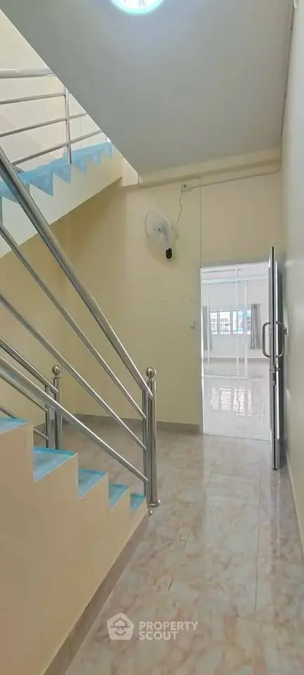 Spacious stairway with modern railing in a bright, airy building interior