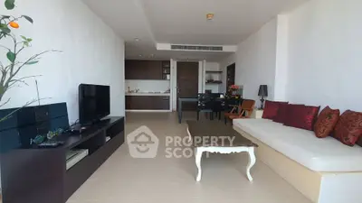 Spacious living room with modern decor and open kitchen layout in a stylish apartment.