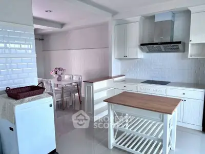 Charming kitchen with white cabinetry and cozy dining area, perfect for family meals.