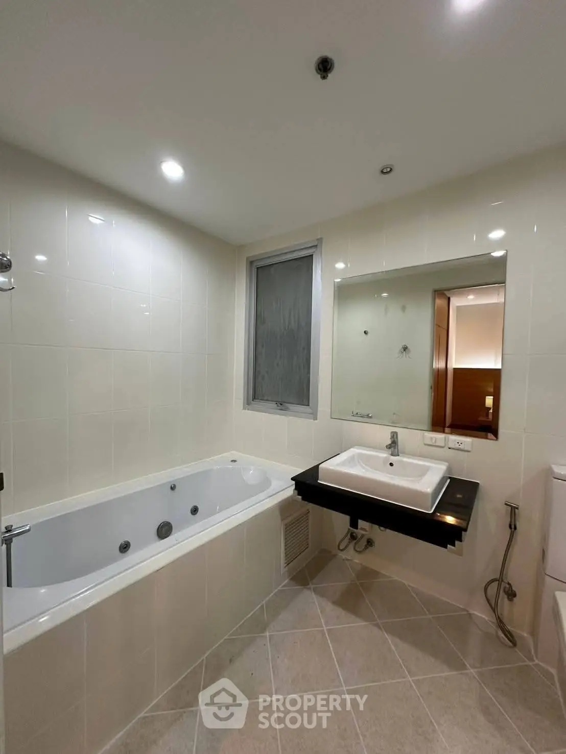Modern bathroom with bathtub and sleek sink in a contemporary apartment.