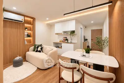 Modern living room with cozy seating and elegant dining area in open layout apartment.