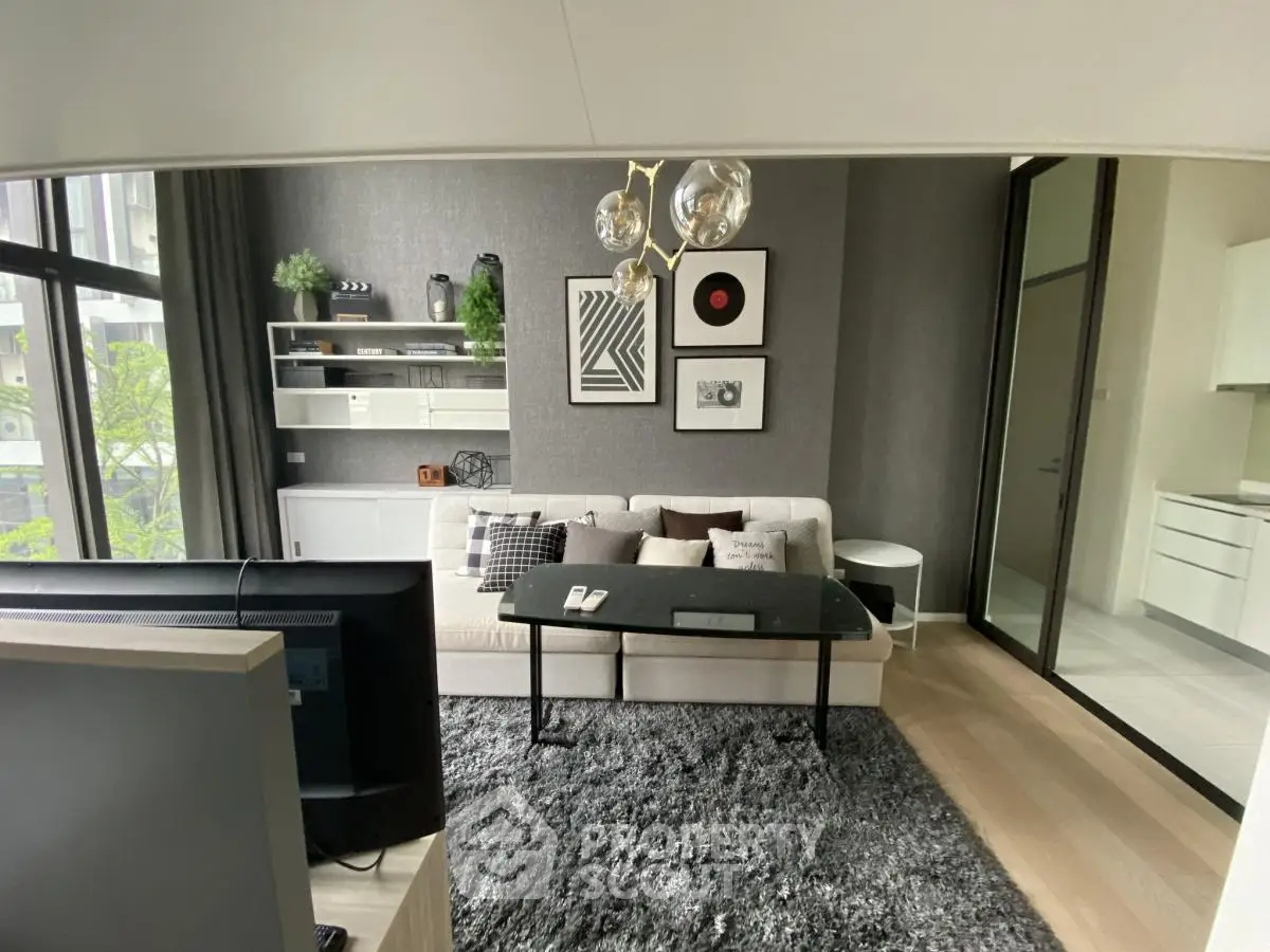 Modern living room with stylish decor and large windows in a contemporary apartment.