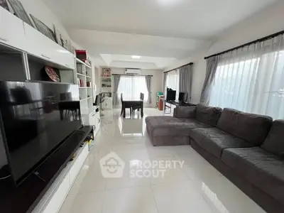 Spacious living room with modern decor and large windows for natural light.