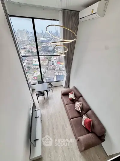 Stunning high-rise living room with panoramic city view and modern decor.