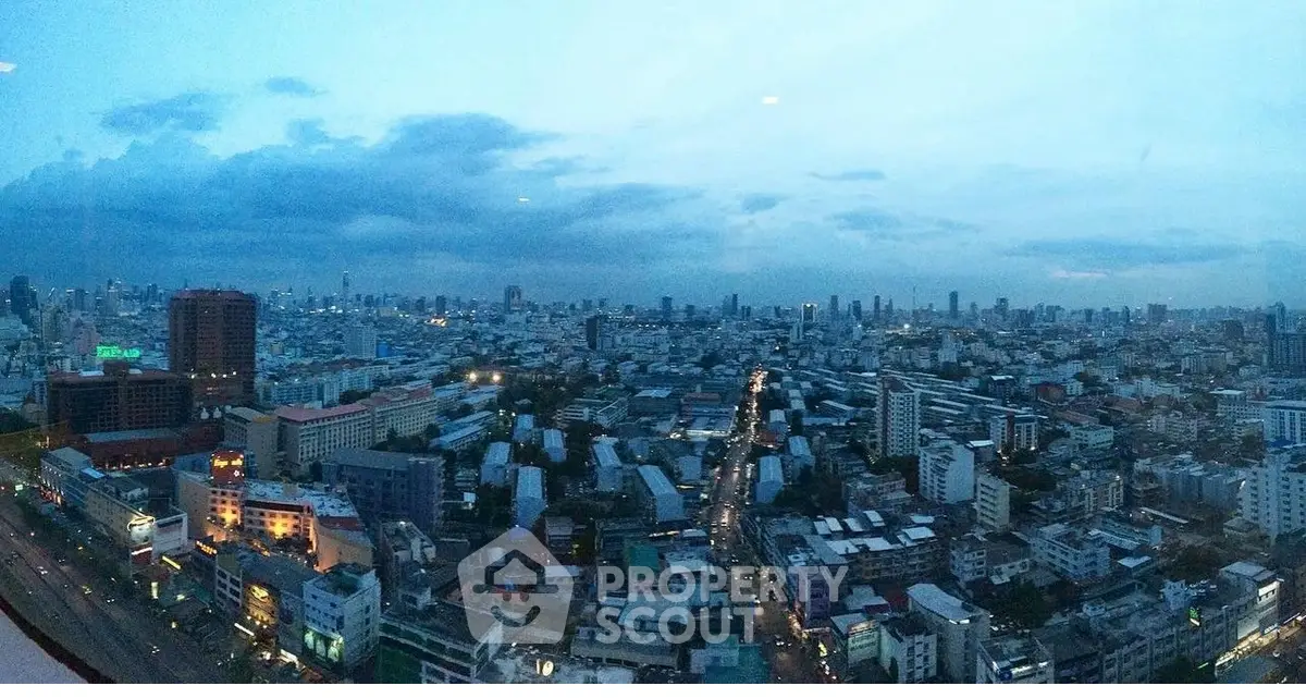 Stunning panoramic cityscape view from a high-rise building at dusk, showcasing urban skyline and vibrant city life.