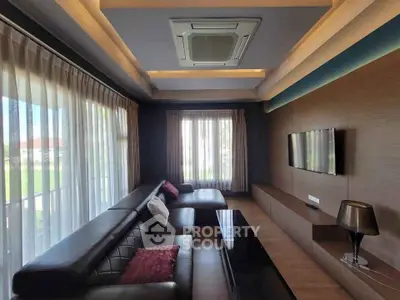 Luxurious modern living room with sleek leather sofa and large windows