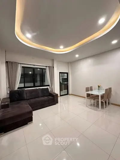 Spacious modern living room with elegant lighting and dining area