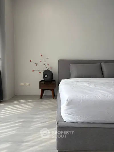 Modern bedroom with stylish decor and natural light