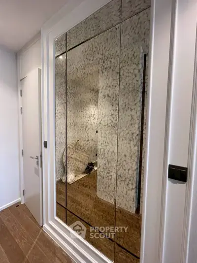 Elegant hallway with mirrored closet doors and modern design