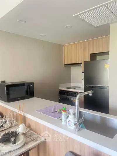 Modern kitchen with sleek appliances and stylish wooden cabinetry