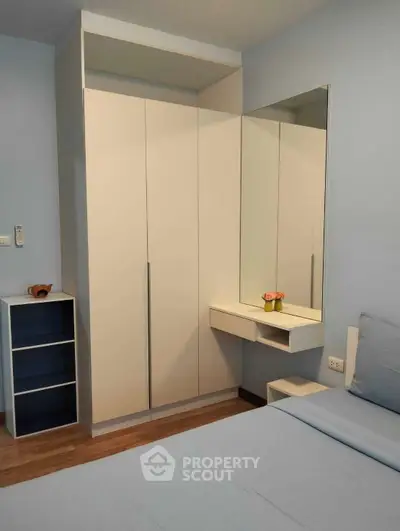 Modern bedroom with sleek wardrobe and cozy decor