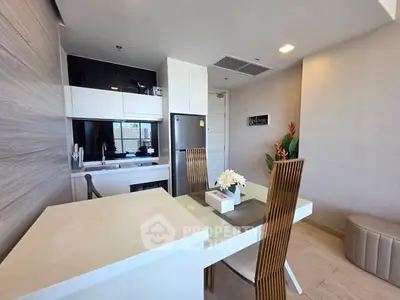 Modern kitchen and dining area with sleek design and natural light