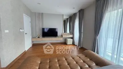 Spacious living room with modern decor and large windows for natural light.