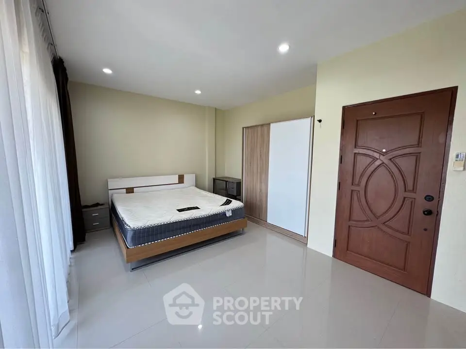 Spacious bedroom with modern design and ample natural light