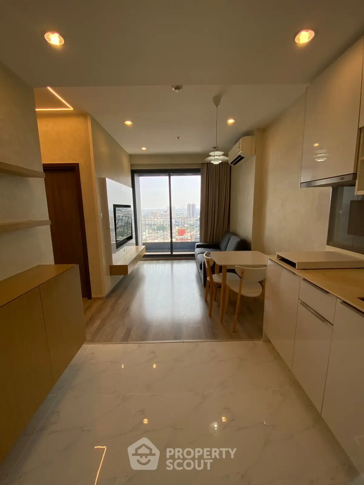 Modern living room with city view, open layout, and stylish furnishings.