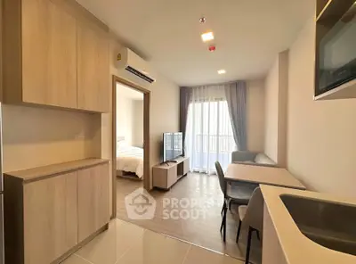 Modern apartment interior with open layout, featuring a cozy living area and stylish kitchen.