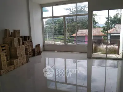 Spacious room with large windows and outdoor view, perfect for natural light lovers.