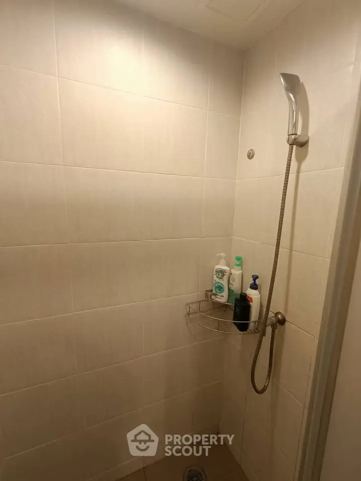 Modern bathroom shower area with tiled walls and showerhead