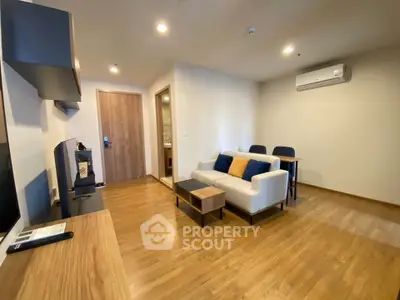 Modern living room with wooden flooring and cozy seating area