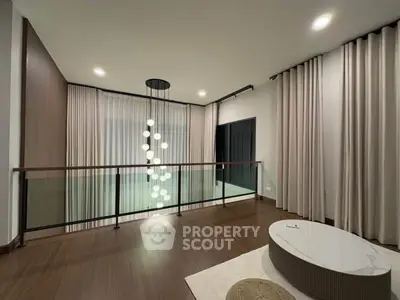 Elegant modern living space with stylish lighting and floor-to-ceiling curtains