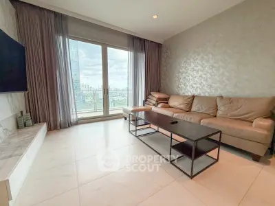 Spacious living room with modern decor and stunning city view from large windows.