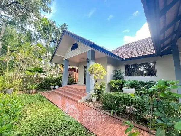 Charming single-story home with lush garden and inviting entrance
