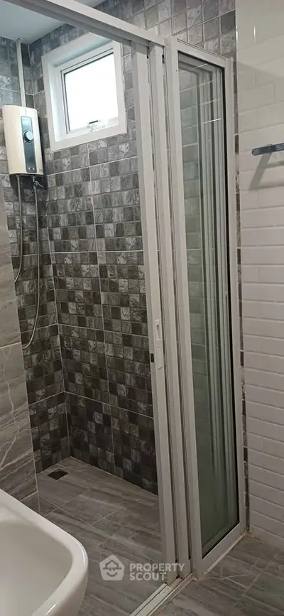 Modern bathroom with sliding glass shower door and stylish tile design