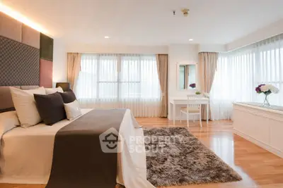 Luxurious and spacious bedroom with elegant decor and ample natural light.