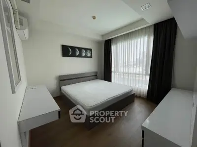 Modern minimalist bedroom with large window and stylish decor