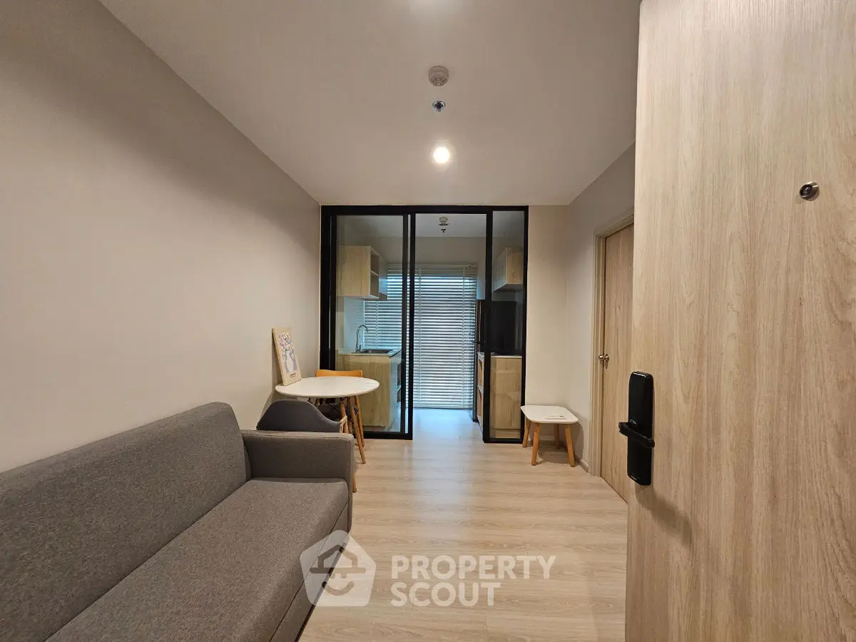 Modern apartment with cozy living room and open kitchen layout.