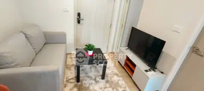 Cozy living room with modern decor, featuring a plush sofa, sleek TV setup, and stylish coffee table.