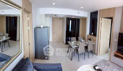 Modern open-plan living and dining area with sleek furniture and stylish decor