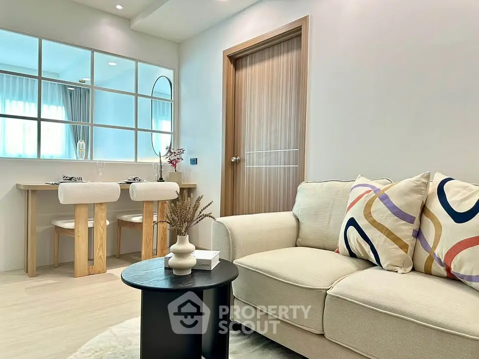 Modern living room with stylish decor and cozy seating in a contemporary apartment.