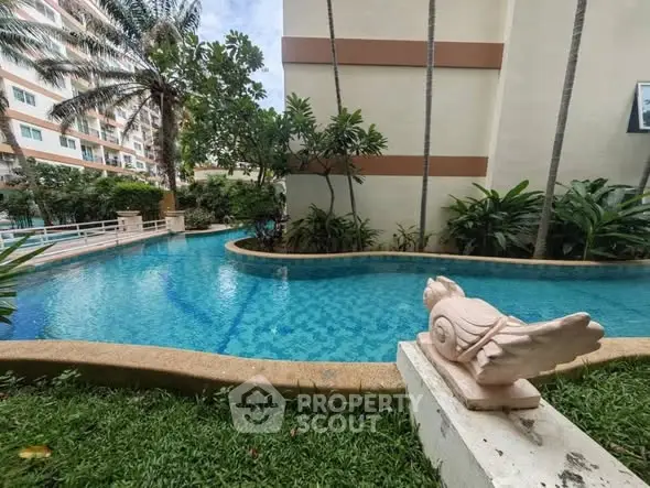 Luxurious residential pool area with lush greenery and modern architecture.