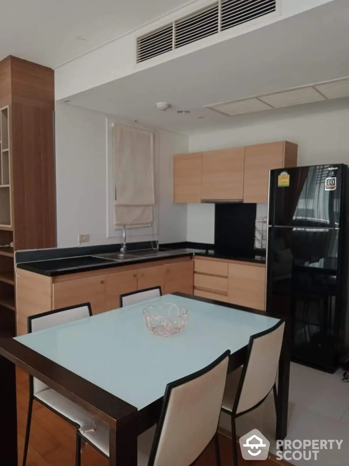 Modern kitchen with sleek black appliances and wooden cabinetry