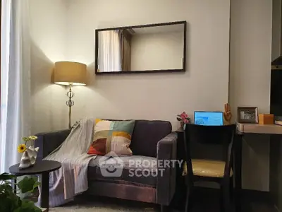 Cozy living room with stylish sofa, modern lamp, and elegant decor