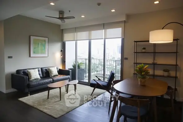 Modern living room with city view, stylish furniture, and natural light.