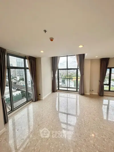 Spacious corner unit with large windows offering a stunning city view, perfect for modern living.