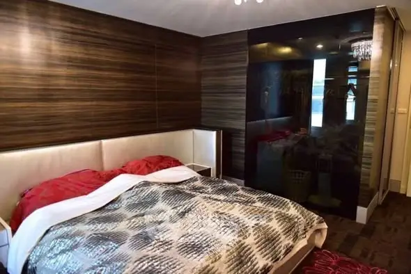 Luxurious bedroom with modern design and elegant wood paneling