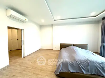 Spacious bedroom with modern design and ample natural light