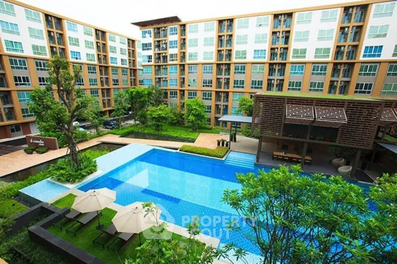 Modern apartment complex with pool and lush garden view