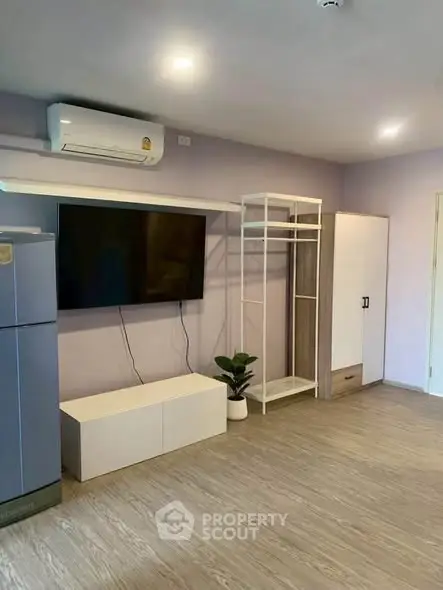 Modern living room with air conditioning and sleek furniture in a stylish apartment.