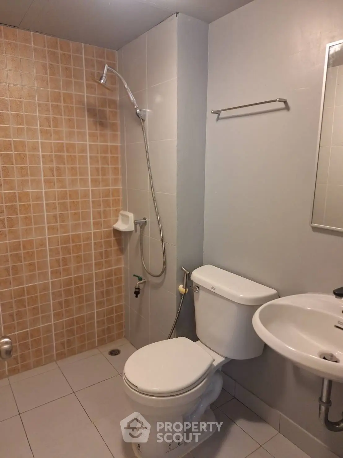 Modern bathroom with shower, toilet, and sink in neutral tones