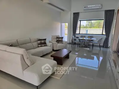 Spacious modern living room with elegant furniture and large window view