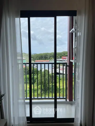 Stunning balcony view with lush greenery and distant hills, perfect for relaxation.