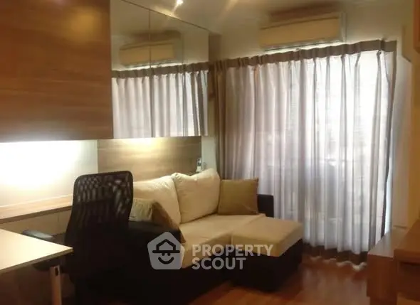 Cozy living room with modern sofa and elegant curtains, perfect for relaxation and comfort.
