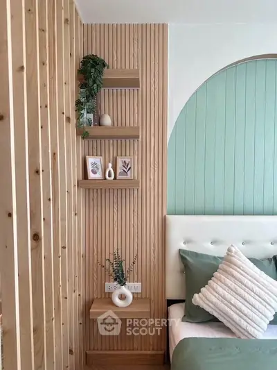 Stylish bedroom with modern wood paneling and decorative shelves, featuring cozy green bedding and elegant decor.