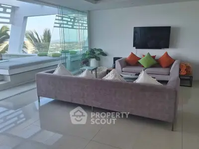 Luxurious living room with modern decor and stunning ocean view, perfect for relaxation and entertainment.
