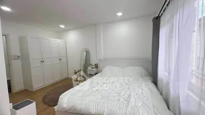 Spacious bedroom with modern decor and ample natural light