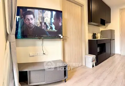 Modern apartment interior with sleek kitchen and wall-mounted TV